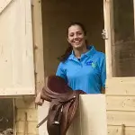 Girl smiling out window of a horse stable in County Antrim