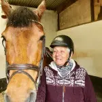 Old woman smiling beside horse in County Antrim