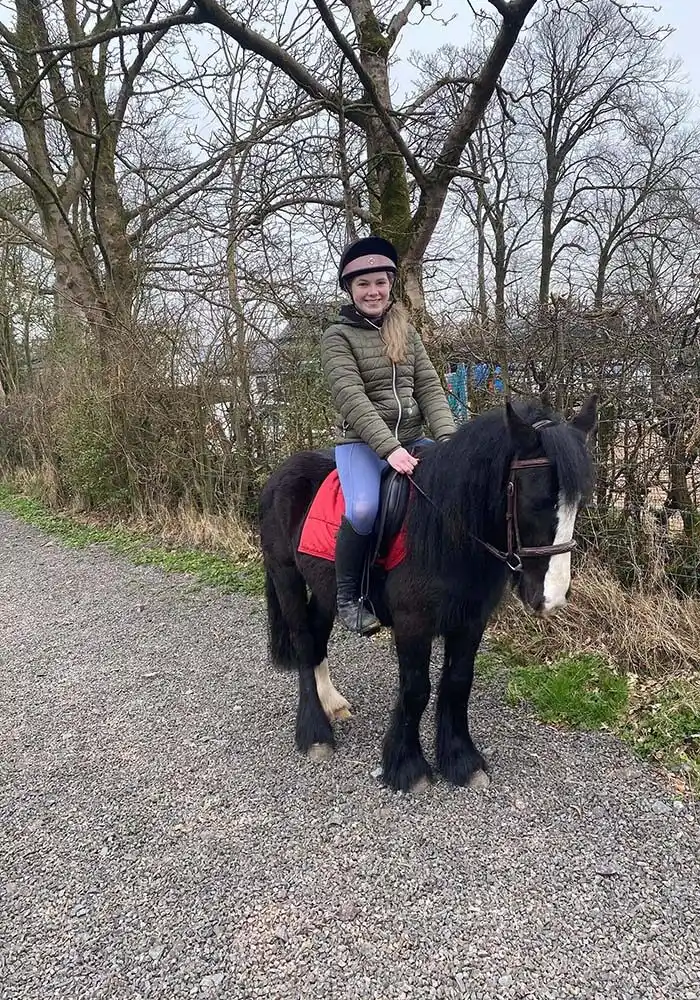 Girl riding a black horse in County Antrim