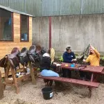 girls cleaning horse saddles in County Antrim