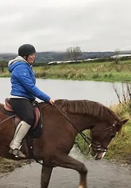 Girl riding beside lake in County Antrim